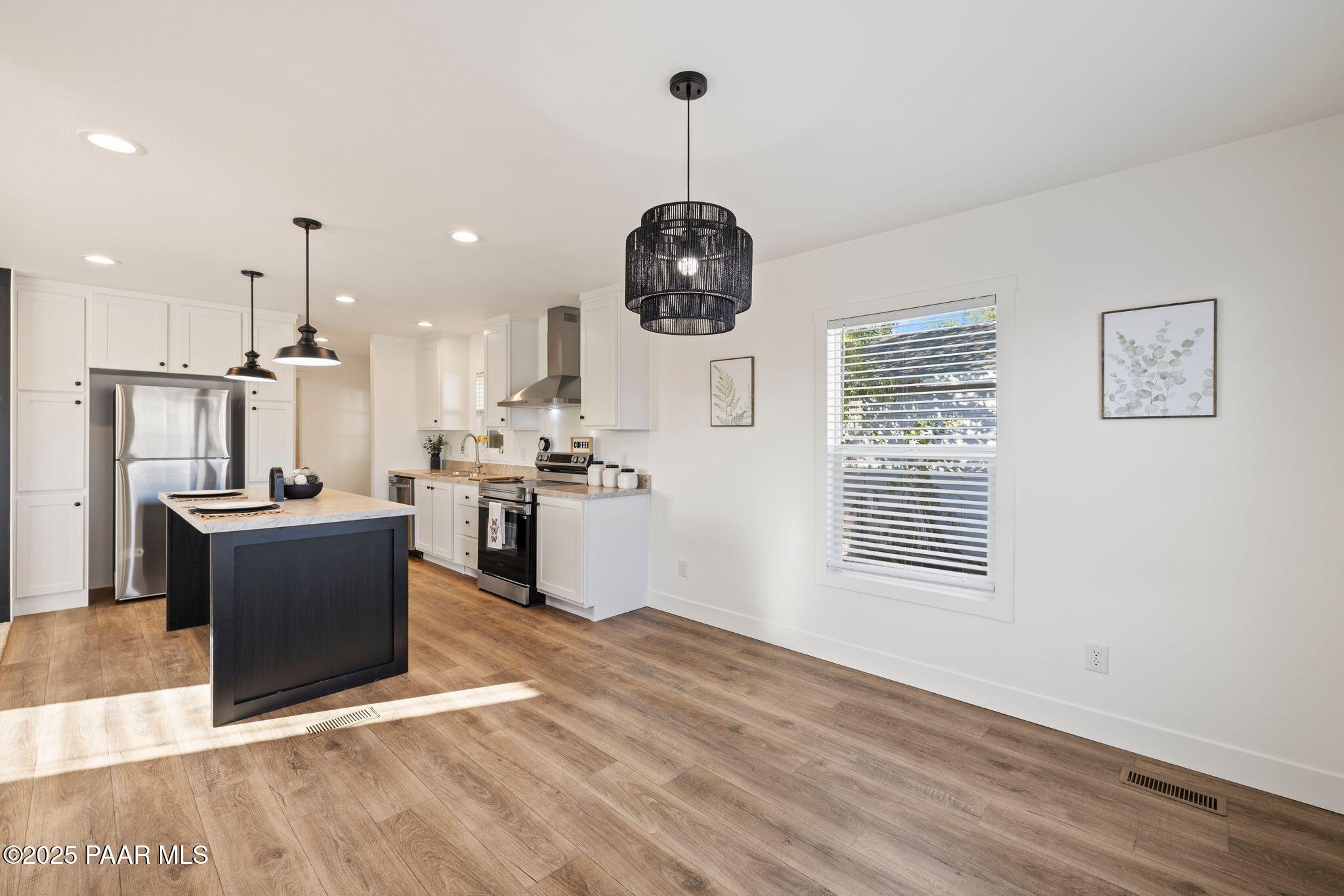 375 West Venice Way Paulden, AZ 86334 - Photo 17 of 41 a kitchen with stainless steel appliances granite countertop a refrigerator a stove top oven a sink dishwasher and a stove with wooden floor
