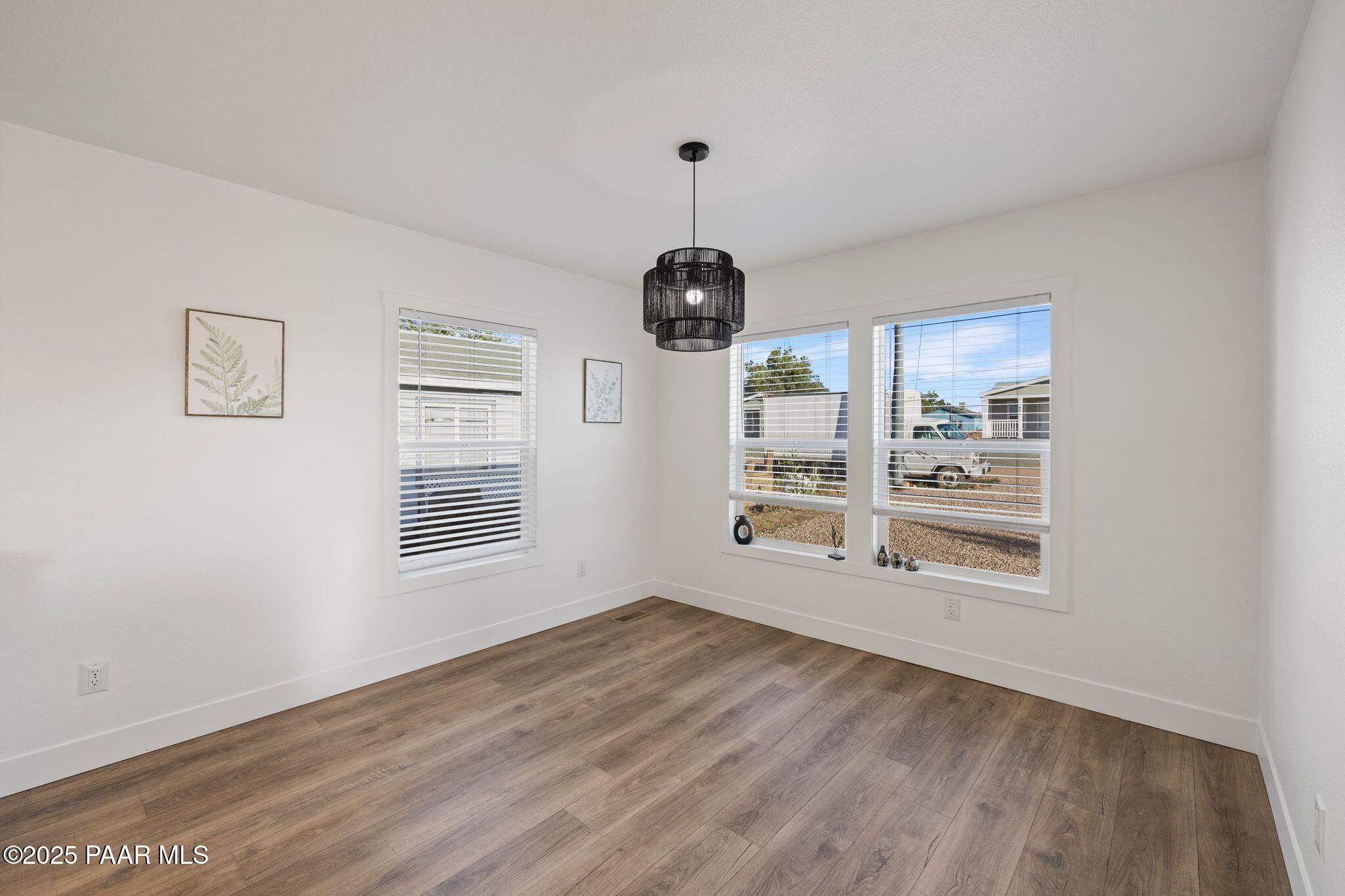 375 West Venice Way Paulden, AZ 86334 - Photo 18 of 41 a view of an empty room with a window and wooden floor
