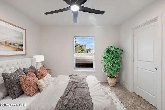 a bed room with a bed and a potted plant
