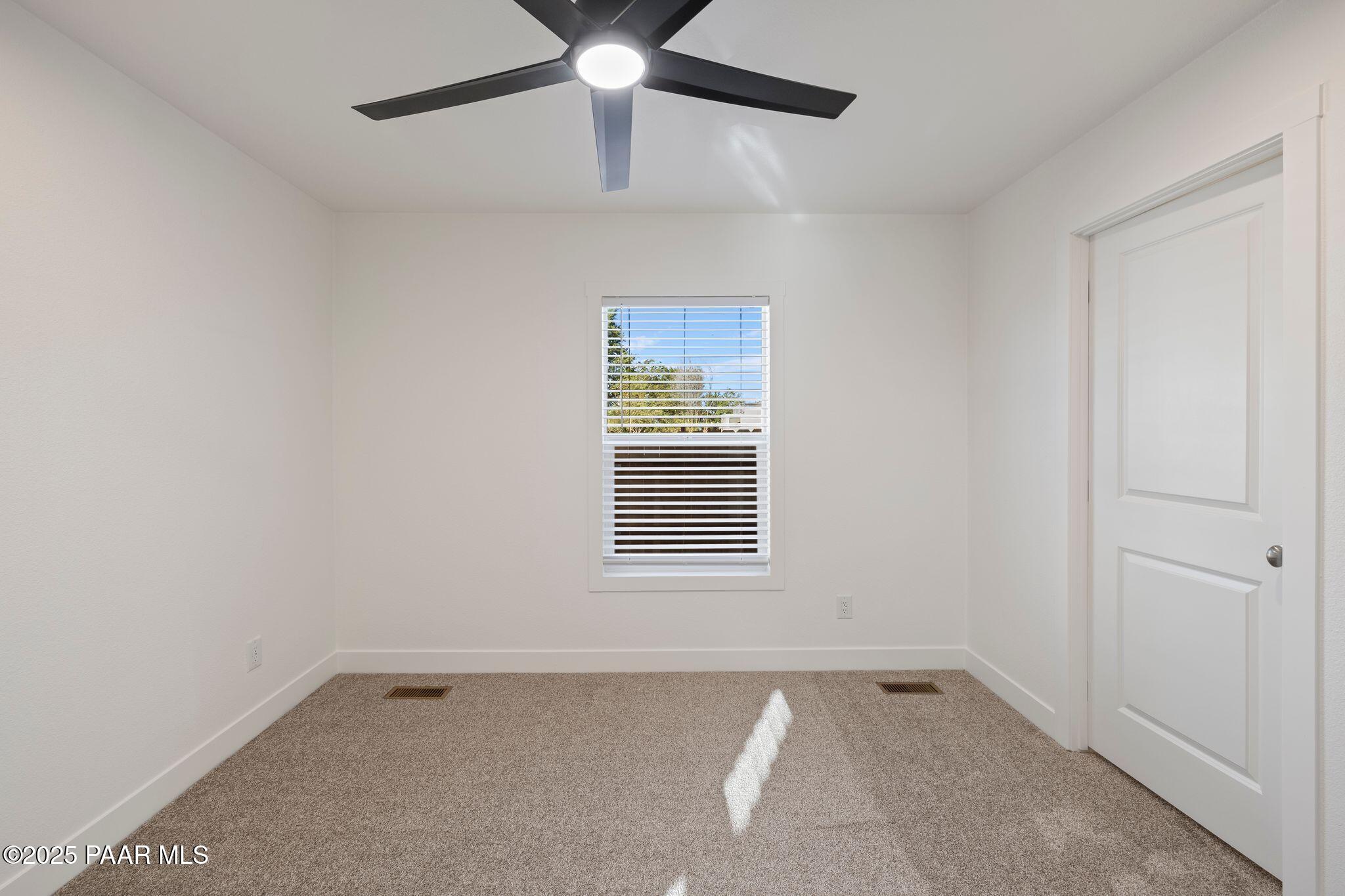 375 West Venice Way Paulden, AZ 86334 - Photo 22 of 41 an empty room with a window and a fan