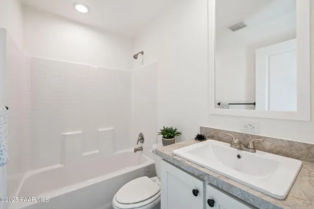 a bathroom with a sink a toilet and bathtub