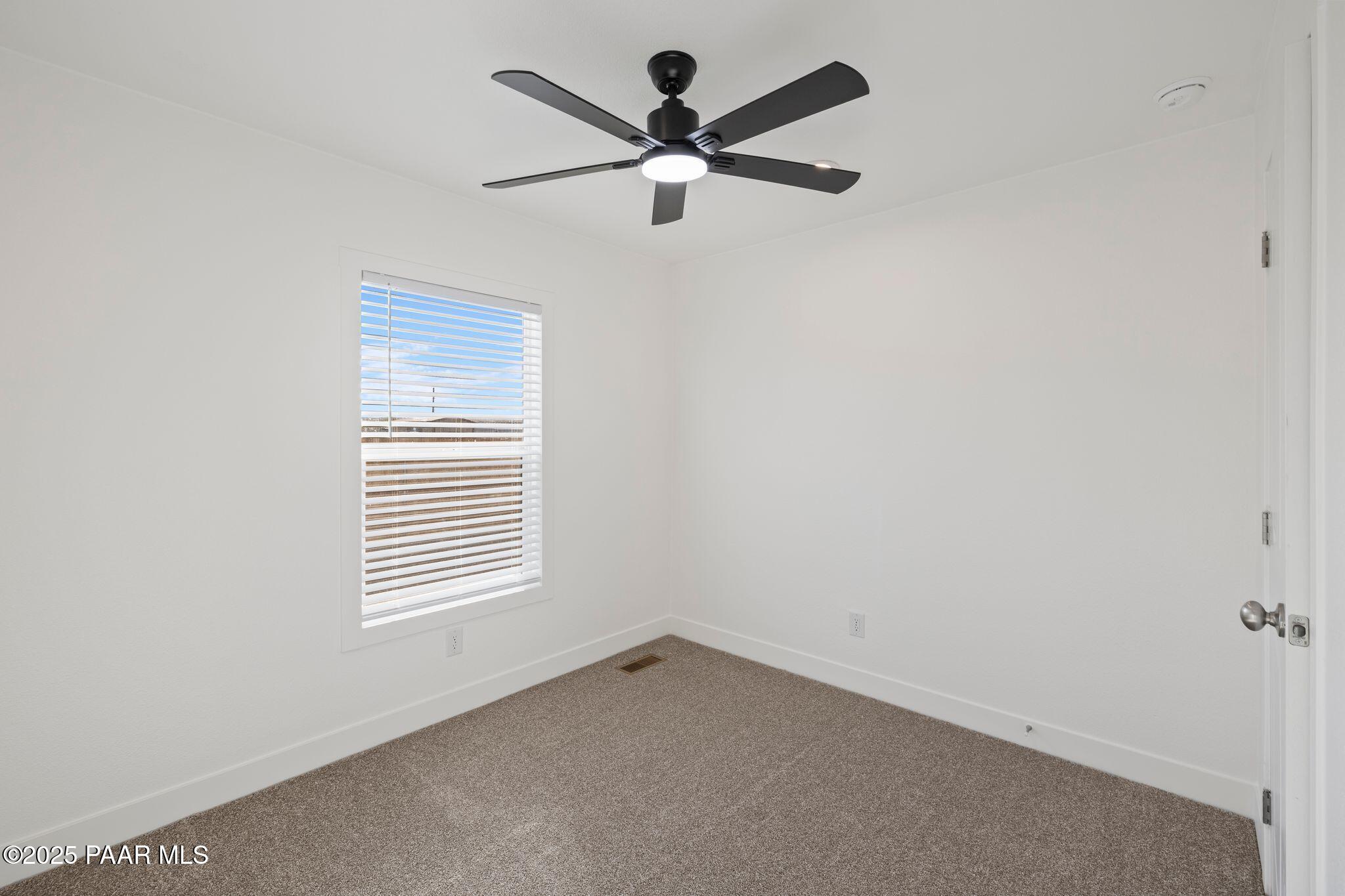 375 West Venice Way Paulden, AZ 86334 - Photo 32 of 41 an empty room with a window and a fan