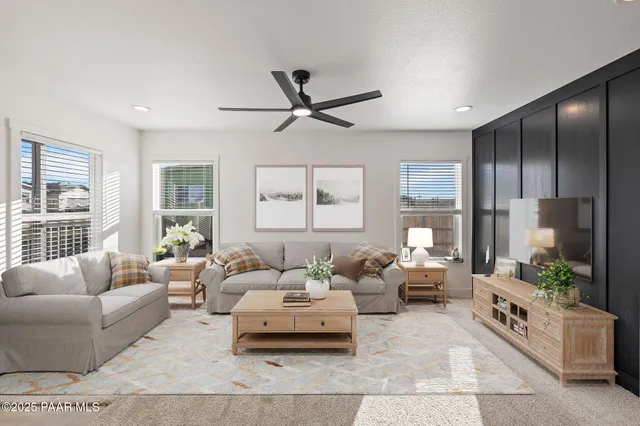 a living room with furniture and windows