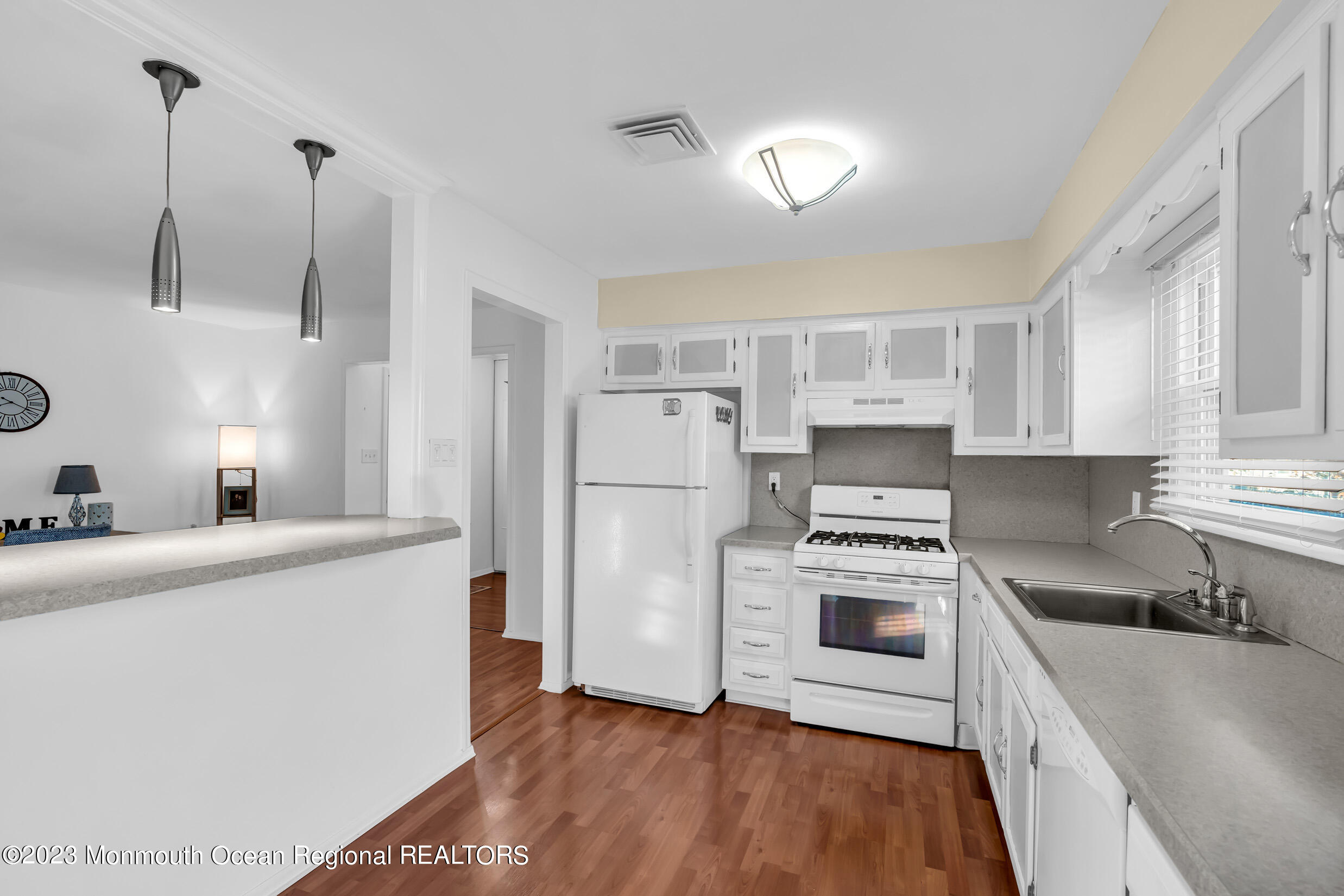 18 Poe Road Brick, NJ 08724 - Photo 16 of 28 a kitchen with a stove a sink and a refrigerator