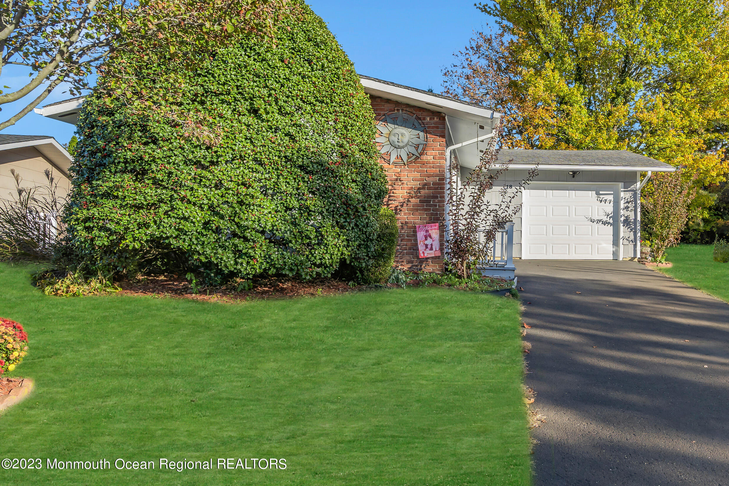 18 Poe Road Brick, NJ 08724 - Photo 4 of 28 a front view of a house with a garden and plants