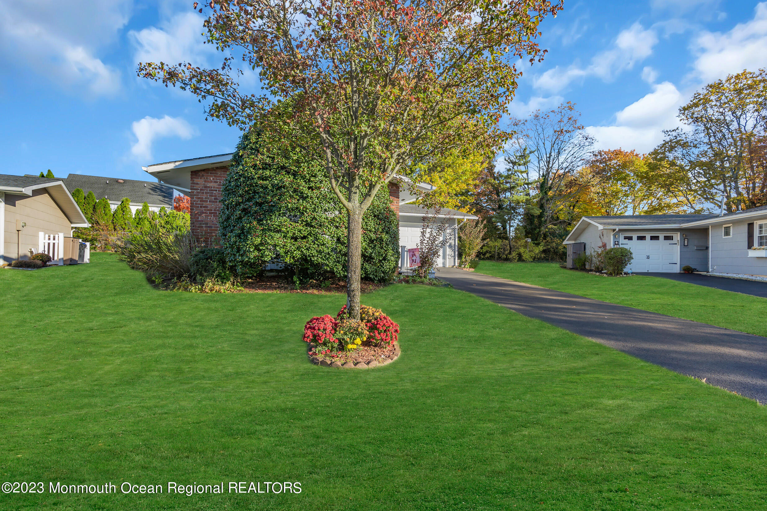 18 Poe Road Brick, NJ 08724 - Photo 6 of 28 a view of a white house with a big yard and potted plants