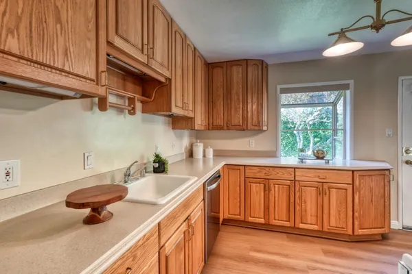 a kitchen with stainless steel appliances a sink a stove and a window