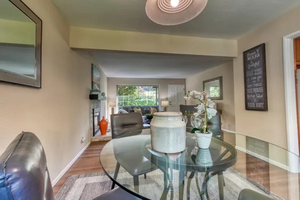 a view of a dining room with furniture and wooden floor