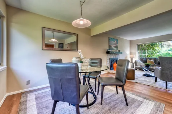 a view of a dining room with furniture window and wooden floor