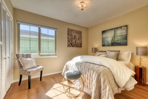 a bedroom with a bed and a chair