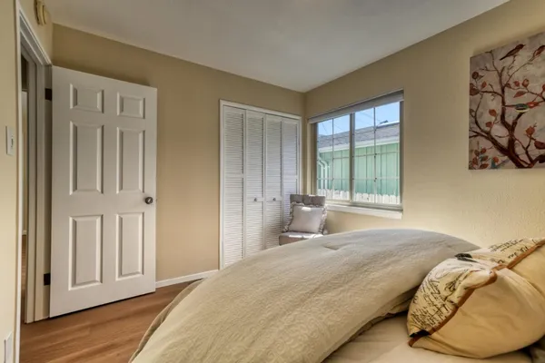a bedroom with a bed and a window