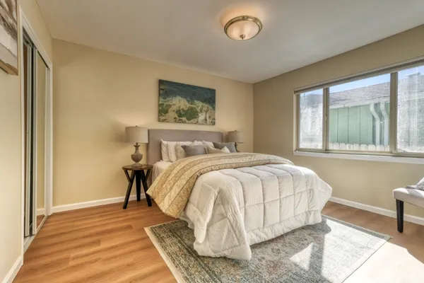 a bedroom with a bed and a window