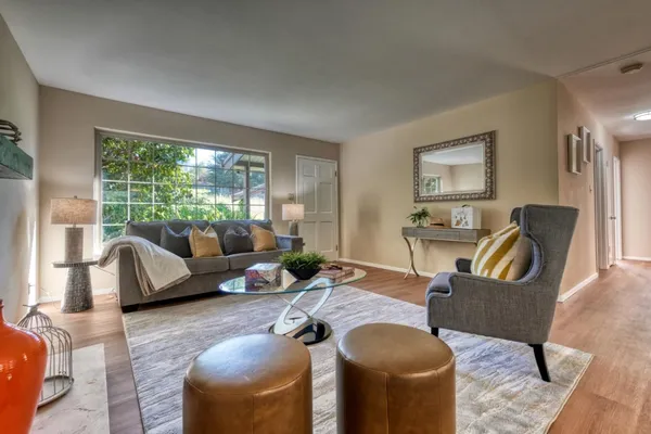 a living room with furniture and a large window