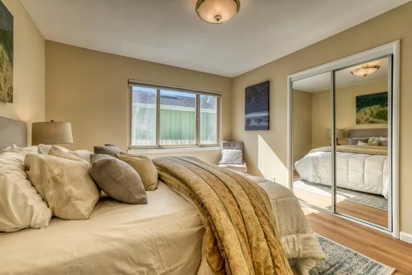 a bedroom with a bed and glass door
