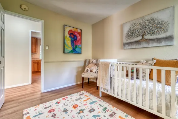 a bedroom with furniture and wooden floor