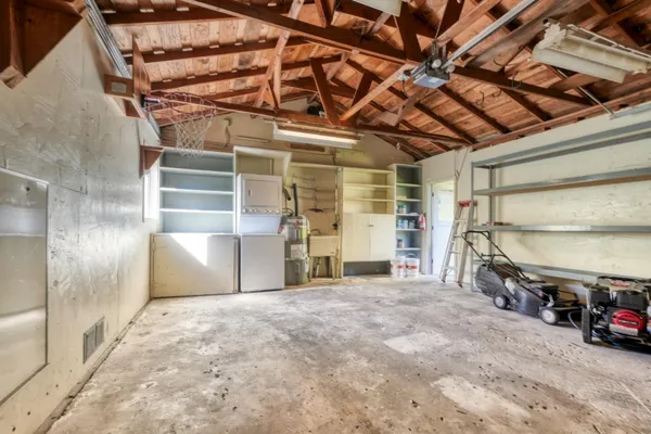 a view of a garage room with wooden walls