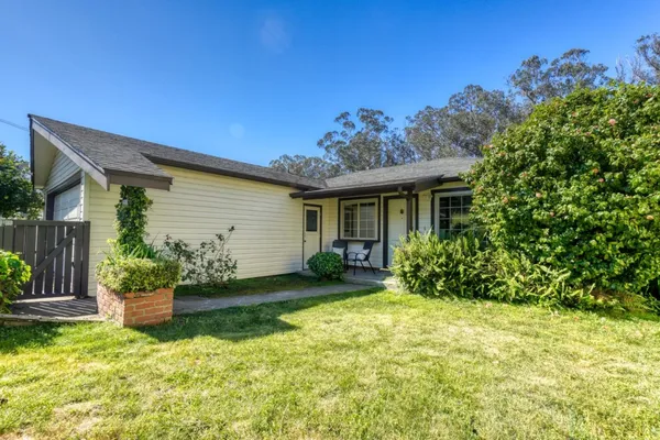 a view of a house with backyard and porch