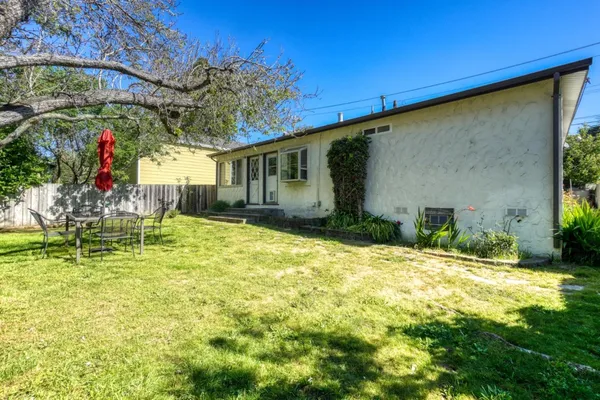 a backyard of a house with yard and outdoor seating