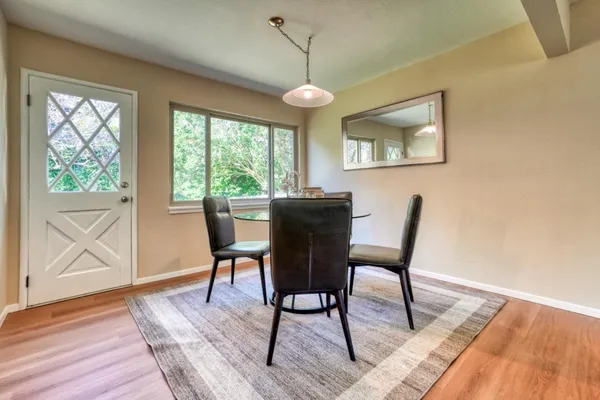 a view of a dining room with furniture window and wooden floor