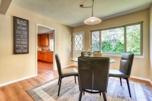 a view of a dining room with furniture window and wooden floor