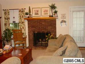 14324 Joseph Clark Road Charlotte, NC 28273 - Photo 4 of 8 a living room with furniture and a fireplace