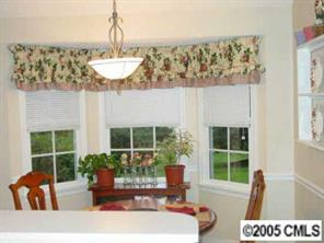 14324 Joseph Clark Road Charlotte, NC 28273 - Photo 7 of 8 a living room with furniture and a potted plant