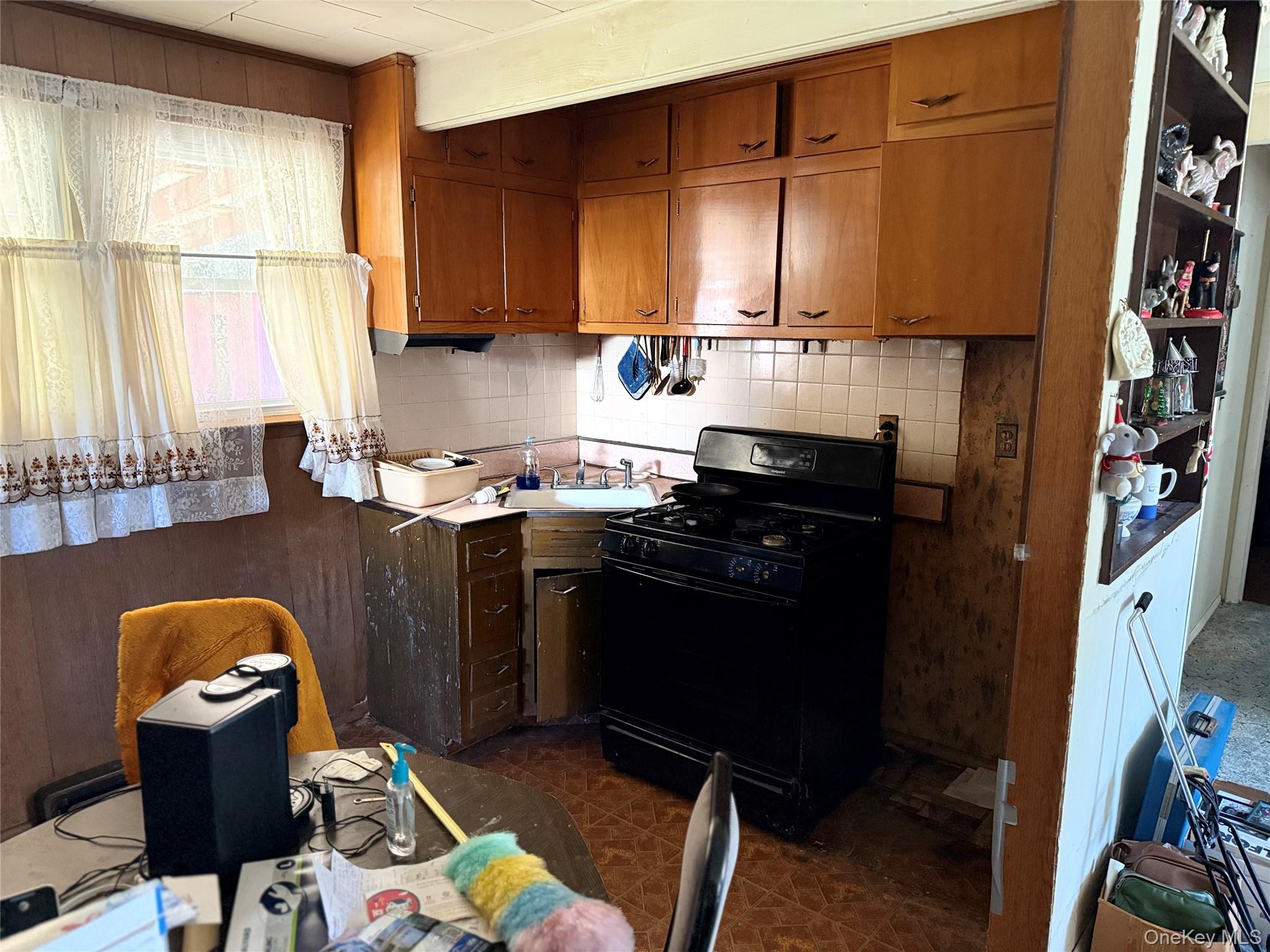 1663 North Thompson Drive Bay Shore, NY 11706 - Photo 7 of 22 a kitchen with stainless steel appliances granite countertop a stove a sink and a refrigerator