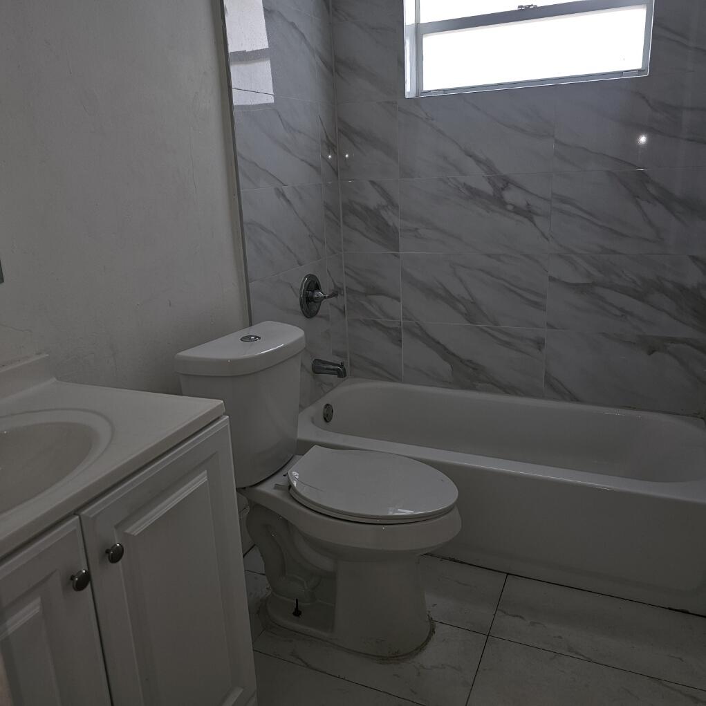 5200 Northwest 18th Place Lauderhill, FL 33313 - Photo 4 of 5 a bathroom with a toilet and a bathtub