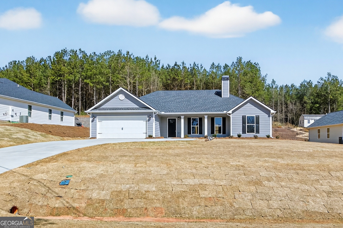 a front view of a house with a yard and trees