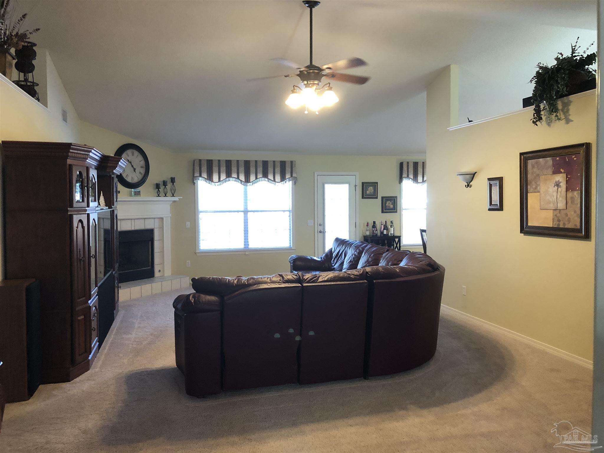 1258 Tate Road Cantonment, FL 32533 - Photo 5 of 35 Very large den with door to the pool and fireplace