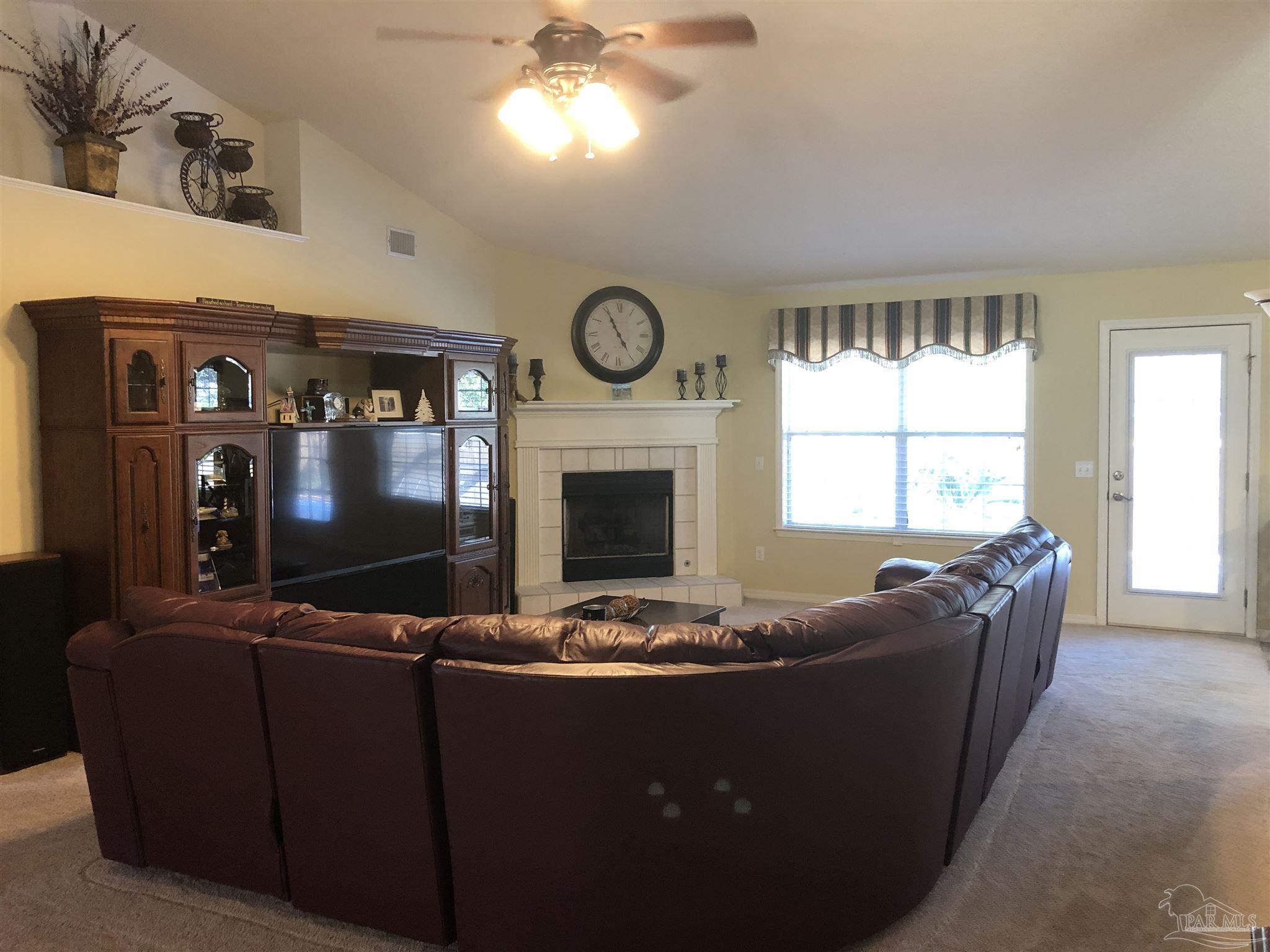 1258 Tate Road Cantonment, FL 32533 - Photo 6 of 35 Very large den with door to pool and fireplace