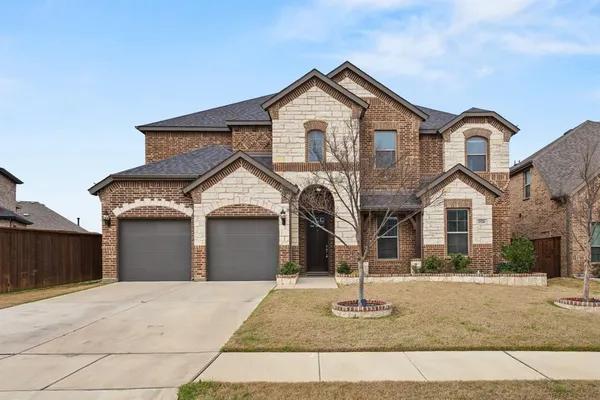 a front view of a house with garage