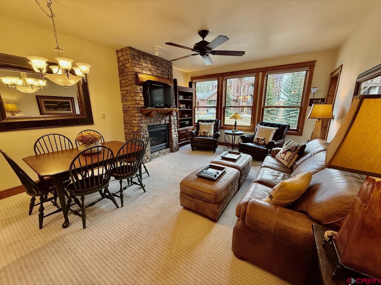 9 Hunter Hill Road, Unit 205 Crested Butte, CO 81225 - Photo 7 of 28 a living room with furniture fireplace and a flat screen tv