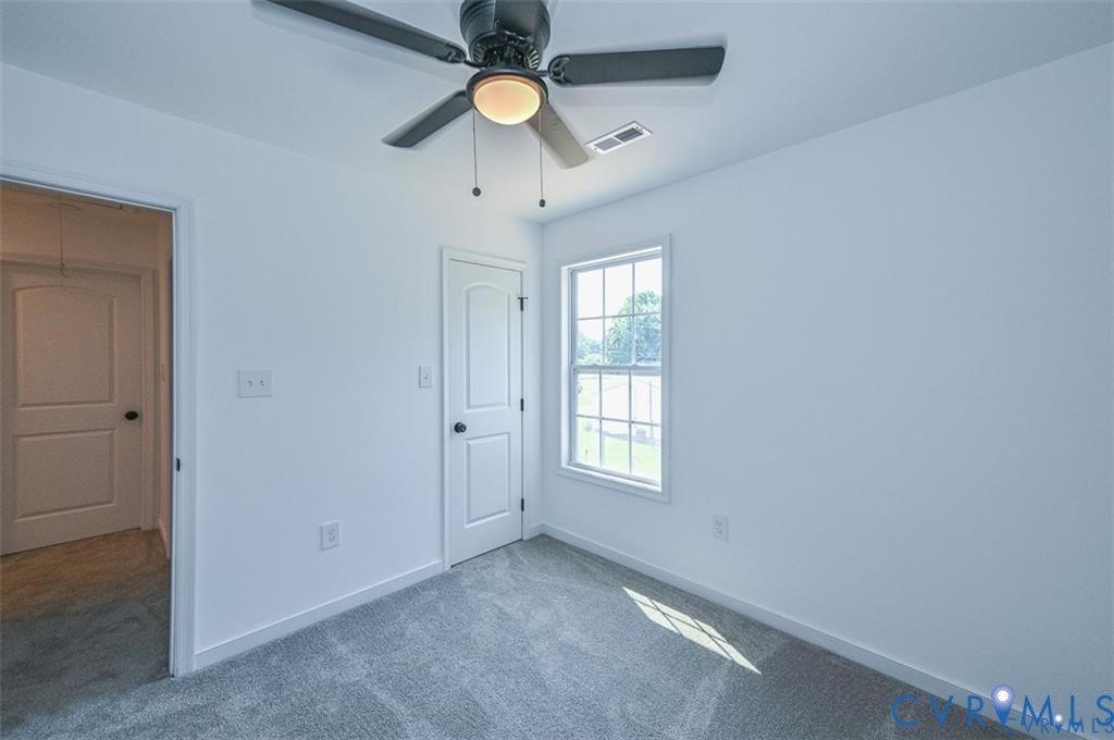 606 West Point Drive Ruther Glen, VA 22546 - Photo 21 of 30 an empty room with windows and fan