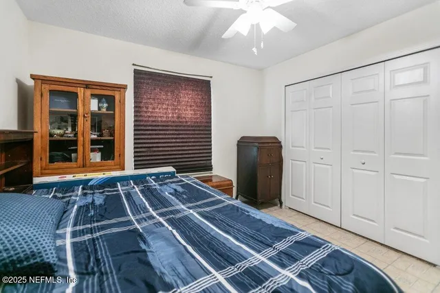 a view of a room with wooden floor closet and windows