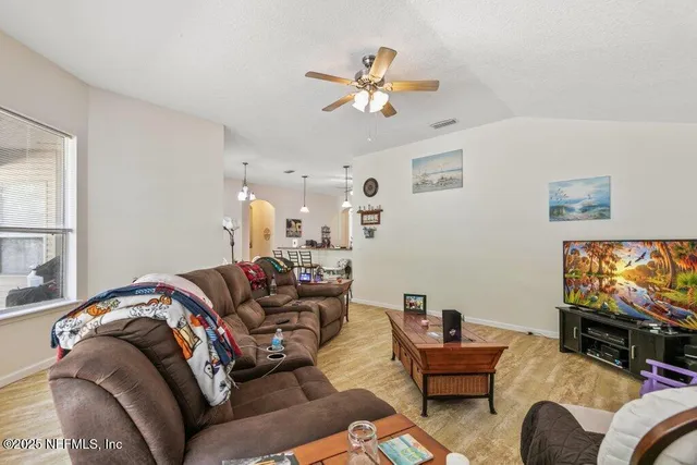 a living room with furniture and a flat screen tv