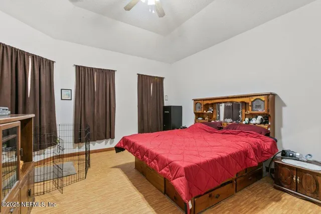 a bedroom with a bed and a chandelier