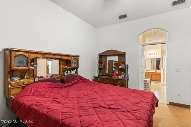 a bed sitting in a bedroom next to a window