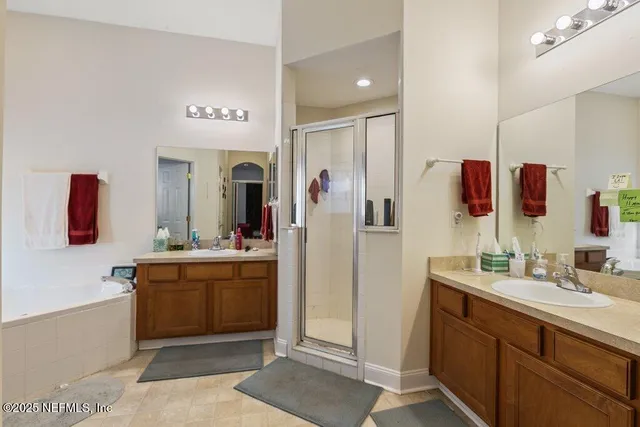 a spacious bathroom with a double vanity sink and mirror