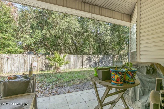 a view of a porch with furniture and garden