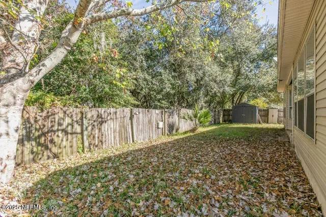 a view of a backyard with pathway