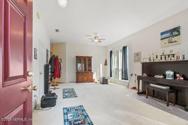 a bedroom with furniture and a mirror