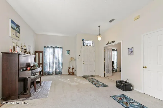 a view of a livingroom with furniture and a window