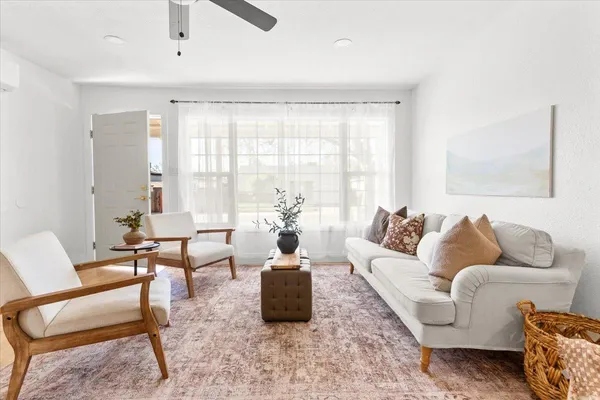 a living room with furniture and a large window