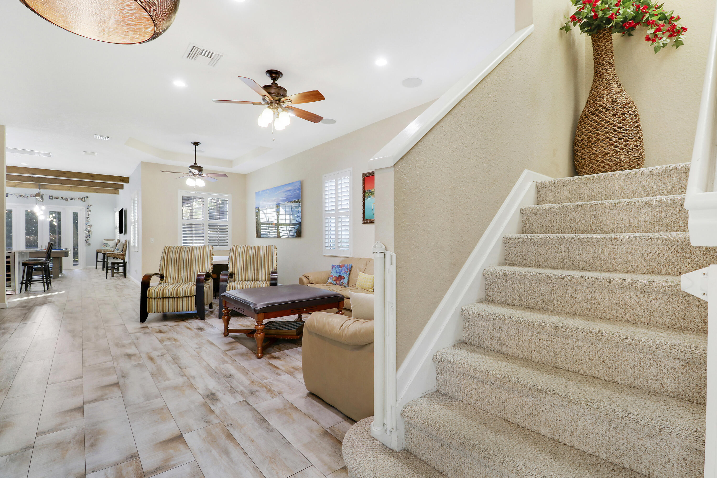 104 Via Azurra Jupiter, FL 33458 - Photo 15 of 41 a living room with furniture and a chandelier