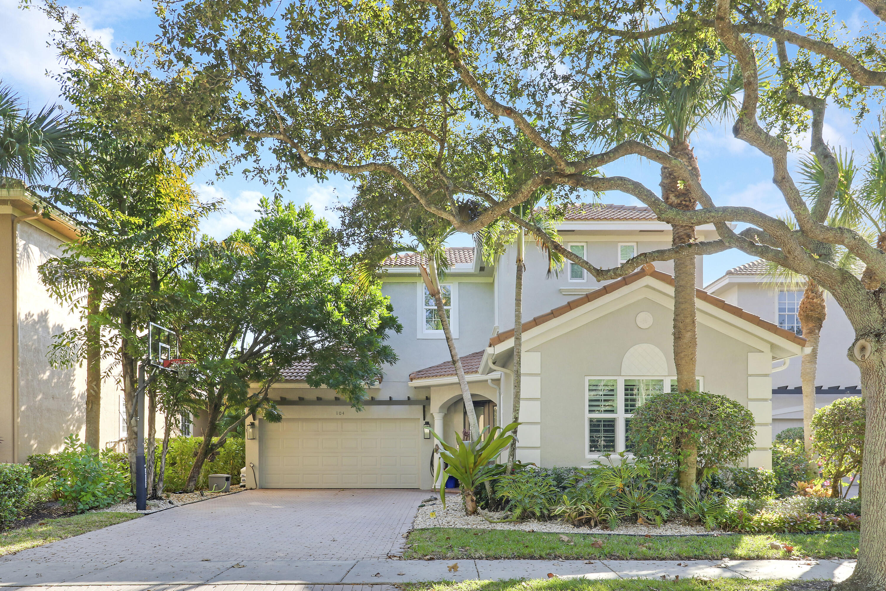 104 Via Azurra Jupiter, FL 33458 - Photo 2 of 41 a white house with a tree in front of it