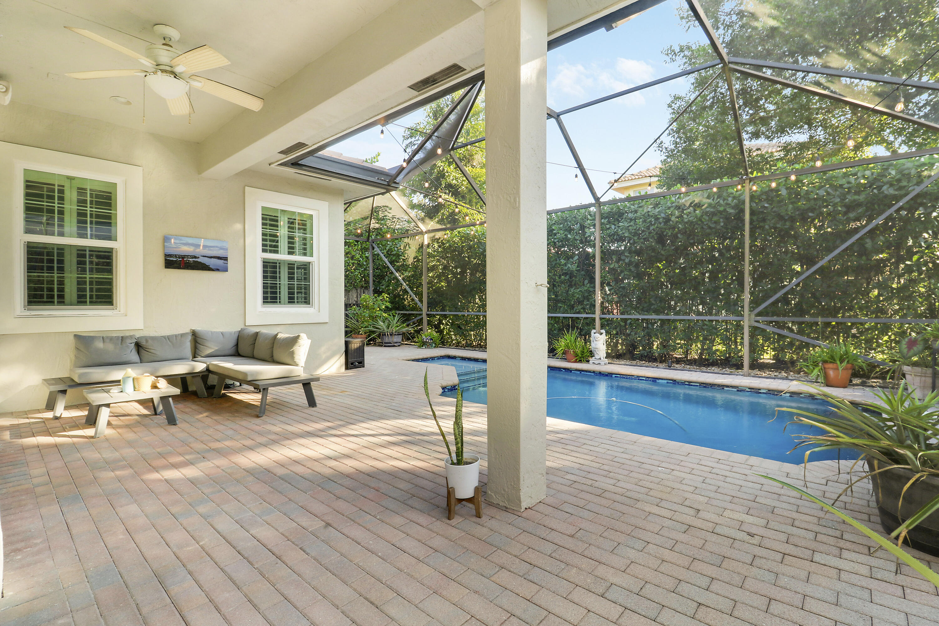 104 Via Azurra Jupiter, FL 33458 - Photo 22 of 41 a living room with patio furniture and a large window