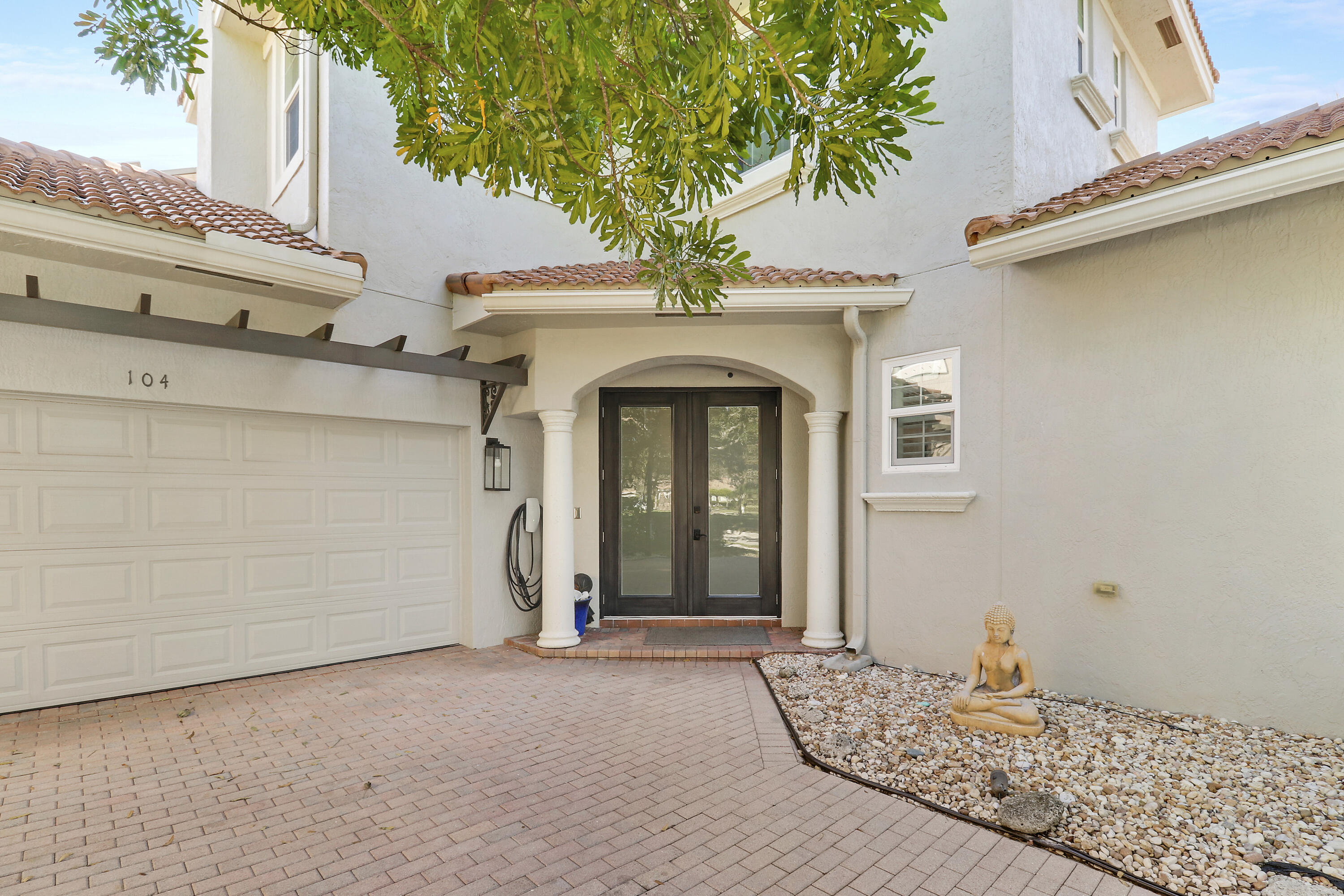 104 Via Azurra Jupiter, FL 33458 - Photo 3 of 41 a front view of a house with garden