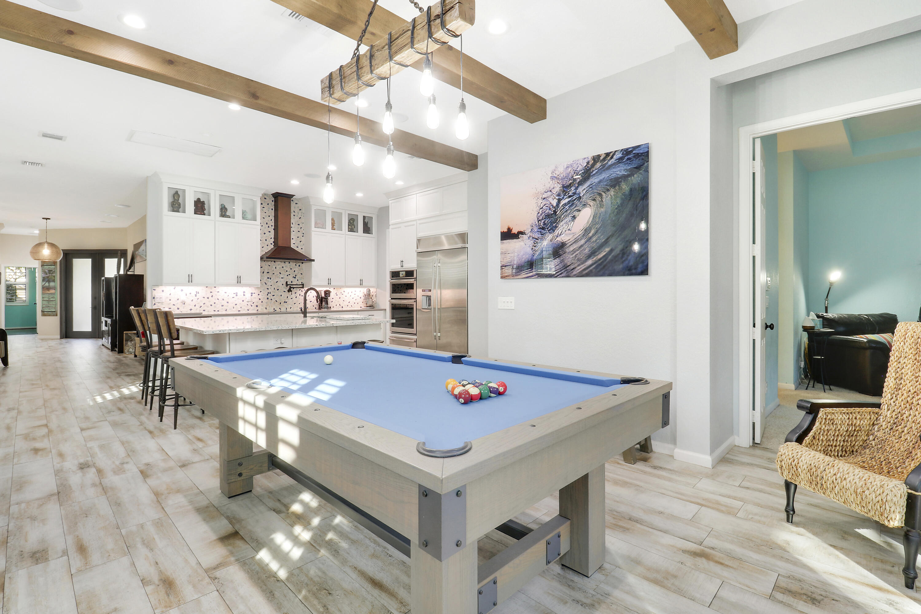 104 Via Azurra Jupiter, FL 33458 - Photo 10 of 41 a living room with dining table and couches with wooden floor