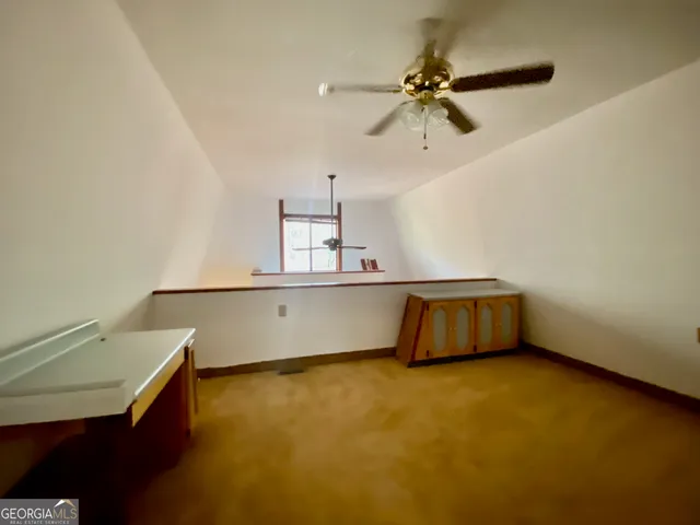 a view of a room with furniture and window